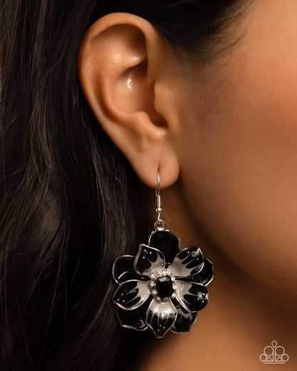 Tropical Treasure Black Flower Earring - Paparazzi Accessories  Featuring a border of white rhinestones, an emerald-cut black bead glimmers from the center of a black and gray-patterned tropical flower. A larger black flower blooms and frames the shimmery flower for a three-dimensional finish. Earring attaches to a standard fishhook fitting.  Sold as one pair of earrings.  P5RE-BKXX-458XX
