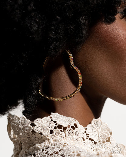 Halftime Hearts Gold Multi Hoop Earring - Paparazzi Accessories  Set in gold lace-like fittings, a collection of multicolored rhinestones curl around a gold heart frame for a feminine display. Earring attaches to a standard post fitting. Hoop measures approximately 2 1/2" in diameter.  Sold as one pair of hoop earrings.  P5HO-MTGD-110XX