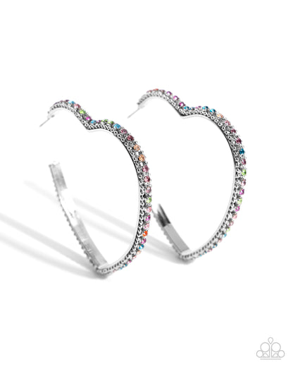 Halftime Hearts Multi Hoop Earring - Paparazzi Accessories  Set in silver lace-like fittings, a collection of multicolored rhinestones curl around a silver heart frame for a feminine display. Earring attaches to a standard post fitting. Hoop measures approximately 2 1/2" in diameter.  Sold as one pair of hoop earrings.  P5HO-MTSV-111XX