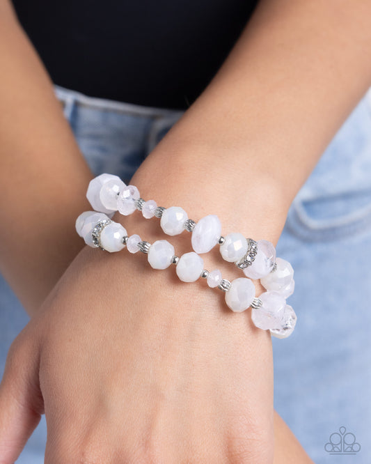 Faceted Fairy Tale White Stretch Bracelet - Paparazzi Accessories  Infused along elastic stretchy bands and connected by a silver vertical bar, a collection of textured silver beads, white rhinestone-encrusted fittings, and glassy, faceted white and milky white beads stack along the wrist for a fairy tale-inspired pop of color.  Sold as one individual bracelet.  P9RE-WTXX-606XX