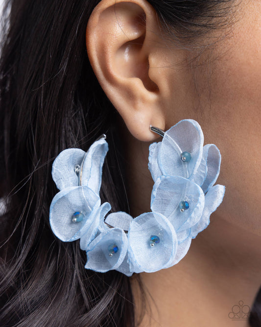 Petaled Pageant Blue Chiffon Flower Hoop Earring - Paparazzi Accessories  A classy collection of Soft Chambray chiffon flowers with dainty blue faceted beaded centers are wrapped along the outside curve of a shiny, silver hoop by shimmery silver wire for a whimsical, posh finish. Earring attaches to a standard post fitting. Hoop measures approximately 1 3/4" in diameter.  Sold as one pair of hoop earrings.  P5HO-BLXX-068XX