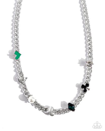 Vegas Vault Green Necklace - Paparazzi Accessories Pronged in place along a high-sheen silver curb chain, a Vegas-styled collection of charms shimmer along the neckline. The various charms include a white pearl, silver heart, white gem, white rhinestone-encrusted horseshoe, an emerald green-painted spade, a black-painted club, and an emerald-green diamond gem. Features an adjustable clasp closure. Sold as one individual necklace. Includes one pair of matching earrings. P2WH-GRXX-413XX