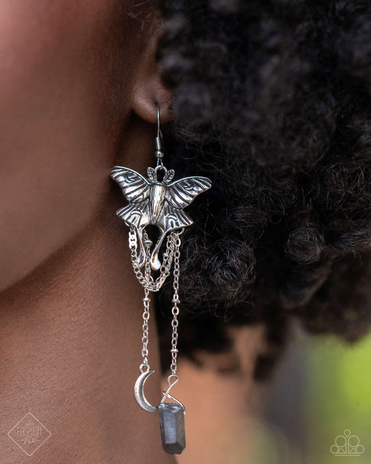 Moth Master - Silver Item #P5WH-SVXX-287YC   Featuring textured detail, a silver moth pendant flies below the ear for an earthy display. Cascading below the silver moth, chiseled hematite stones, a silver crescent moon, and an opalescent-centered silver star create additional starry detail. Earring attaches to a standard fishhook fitting.  Sold as one pair of earrings.