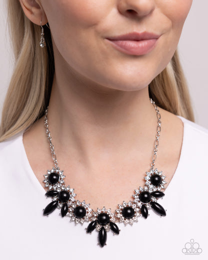 Flair for the Feminine Black Necklace - Paparazzi Accessories  Bordered in white rhinestone-embellished pronged silver fittings, a collection of round and marquise-cut shiny black acrylic beads create a feminine, floral-like display below the neckline. Features an adjustable clasp closure.  Sold as one individual necklace. Includes one pair of matching earrings.  P2ST-BKXX-240XX