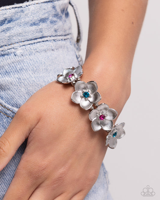 General Grandeur Blue Flower Stretch Bracelet - Paparazzi Accessories Featuring blue and fuchsia gem centers, highly-textured silver flowers alternate and stretch along elastic stretchy bands around the wrist for a whimsical centerpiece. Sold as one individual bracelet. SKU: P9RE-BLXX-258XX