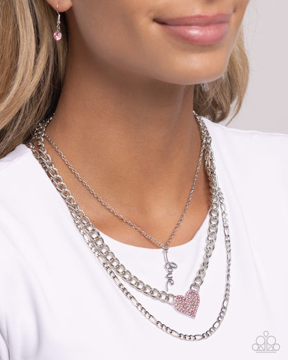 Luxurious Love Pink Heart Necklace - Paparazzi Accessories  Three mismatched silver chains loop and layer below the neckline. Featured on the uppermost chain, set in a curly cursive font, silver letters spell out the word "love" while the centermost chain features a light rose rhinestone-encrusted heart for a romantic radiant display. Features an adjustable clasp closure.  Sold as one individual necklace. Includes one pair of matching earrings.  P2RE-PKXX-423XX