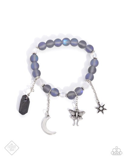 Moth Maestro - Blue Item #P9SE-BLXX-459YC   Infused along an elastic stretchy band, a collection of clear and blue-brushed hematite beads, and silver discs combine for a pop of color around the wrist. Various earthy and stellar charms drip below the display on differing lengths of silver chain including a highly-detailed silver moth, a chiseled hematite stone, a silver crescent moon, and an opalescent-centered silver star for a majestic finish.  Sold as one individual bracelet.