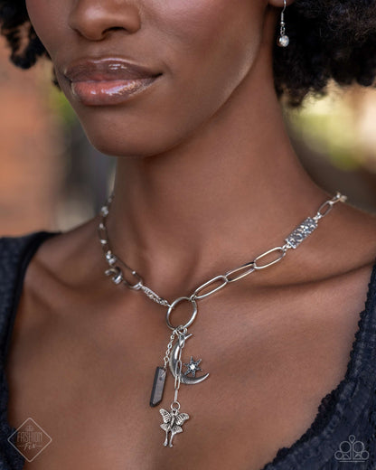 Celestial Confidence - Silver Item #P2WH-SVXX-387YC A dainty silver paperclip chain gradually increases in size as it elongates down the neckline, accentuated by a link resembling a safety pin, dotted with a crescent moon, and embossed with starry details. The embellished chain leads to a collection of charms, including a chiseled piece of hematite, a three-dimensional star nestled in the curve of a crescent moon, and a moth with intricate detailing. Includes one pair of matching earrings.