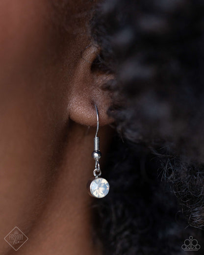 Celestial Confidence - Silver Item #P2WH-SVXX-387YC A dainty silver paperclip chain gradually increases in size as it elongates down the neckline, accentuated by a link resembling a safety pin, dotted with a crescent moon, and embossed with starry details. The embellished chain leads to a collection of charms, including a chiseled piece of hematite, a three-dimensional star nestled in the curve of a crescent moon, and a moth with intricate detailing. Includes one pair of matching earrings.