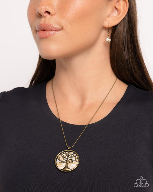 Tree Talisman Brass Necklace - Paparazzi Accessories  Gliding along a brass snake chain, a brass tree stretches and grows across a patterned white stone brass pendant for a grounded grandiose display. Features an adjustable clasp closure. As the stone elements in this piece are natural, some color variation is normal.  Sold as one individual necklace. Includes one pair of matching earrings.  P2SE-BRXX-166XX