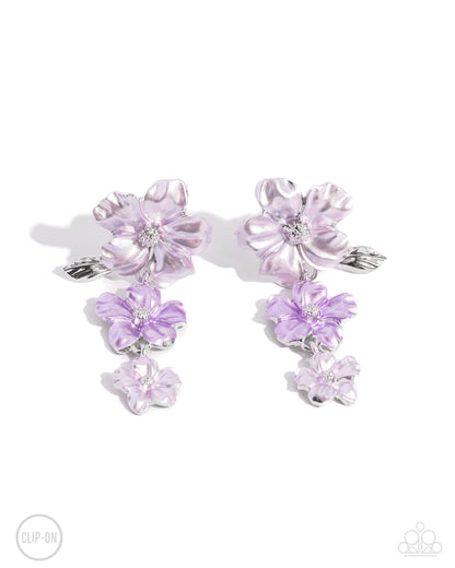 Balanced Bouquet Purple Flower Clip-On Earring - Paparazzi Accessories  Dotted with silver-studded centers, metallic light purple and lavender flowers bloom and alternate, gradually decreasing in size as they cascade below the ear. The largest flower blossoms across a textured collection of silver leaves, invoking a festive spirit. Earring attaches to a standard clip-on fitting.  Sold as one pair of clip-on earrings.  P5CO-PRXX-027ZR