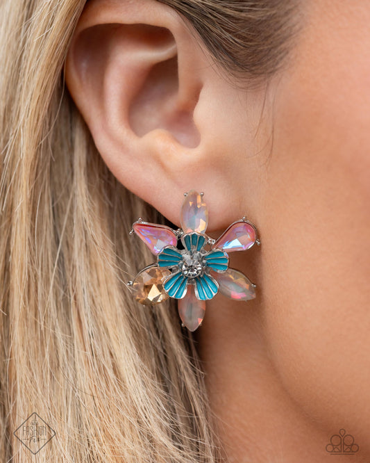 Hamptons Habit - Multi Item #P5PO-MTXX-136AD    Pressed in silver-pronged fittings, a collection of light topaz and pink gems, brushed in a hazy UV glow, bloom behind a silver flower with painted blue petals and a white rhinestone center for a colorfully coastal look. Earring attaches to a standard post fitting.  Sold as one pair of post earrings.