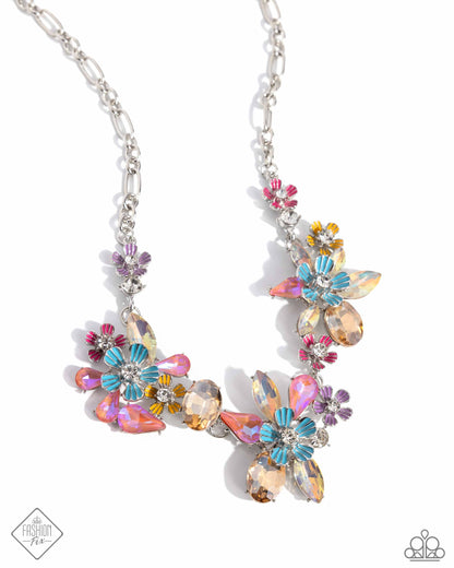 Hamptons Haute - Multi Item #P2RE-MTXX-251AD    Featuring a spectrum of UV shimmer, faceted topaz, and pink gems, create abstract floral pendants along the neckline, accented by silver flowers with painted petals and additional white rhinestones from an abstract silver chain for a whimsical, coastal look. Features an adjustable clasp closure.  Sold as one individual necklace. Includes one pair of matching earrings.