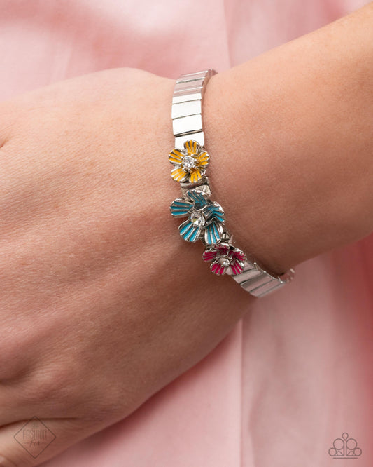 Hamptons Headline - Multi Item #P9RE-MTXX-169AD   A trio of silver flowers, with rhinestone centers and colorfully painted petals, glistens atop a succession of sleek silver vertical bars threaded along stretchy bands, for a whimsical design atop the wrist.  Sold as one individual bracelet.