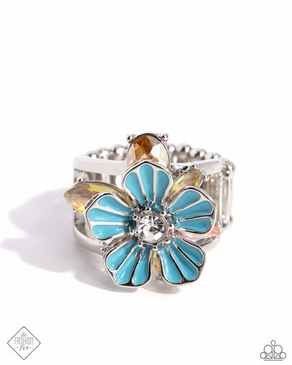 Hamptons Holiday - Blue Item #P4WH-BLXX-218AD   Featuring a white rhinestone center, a blue-painted silver flower radiates from an airy silver band. Opalescent topaz and pink gems in various cuts blossom outward from the blue flower in silver-pronged fittings for a dreamy, coastal-inspired centerpiece. Features a stretchy band for a flexible fit.  Sold as one individual ring.