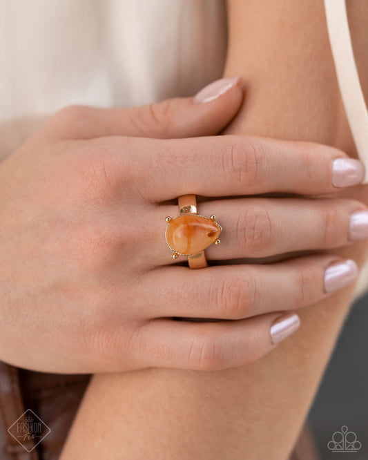 Marbled Moderato - Orange Item #P4RE-OGXX-075ZW   Featuring a marbled swirl, a dramatic orange teardrop bead nestles inside a pronged gold frame atop a thin gold band for a vintage, refined twist. Features a dainty stretchy band for a flexible fit.  Sold as one individual ring.