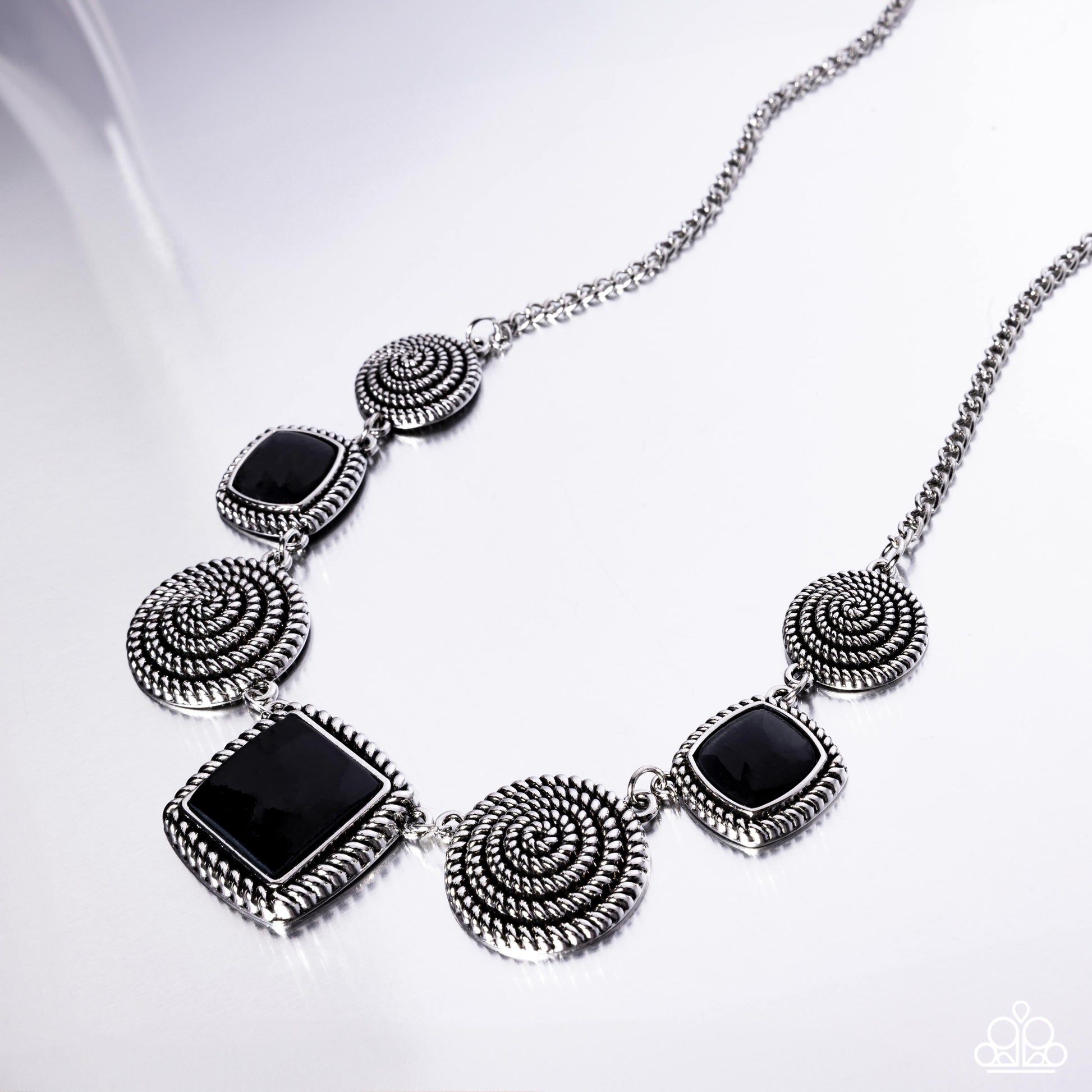 Spiral Sass Black Necklace - Paparazzi Accessories  Pressed in textured spiral silver frames, a collection of glassy black cat's eye square stones alternate with glistening silver spirals along the neckline for a sassy showcase of color. Features an adjustable clasp closure.  Sold as one individual necklace. Includes one pair of matching earrings.  P2RE-BKXX-496XX