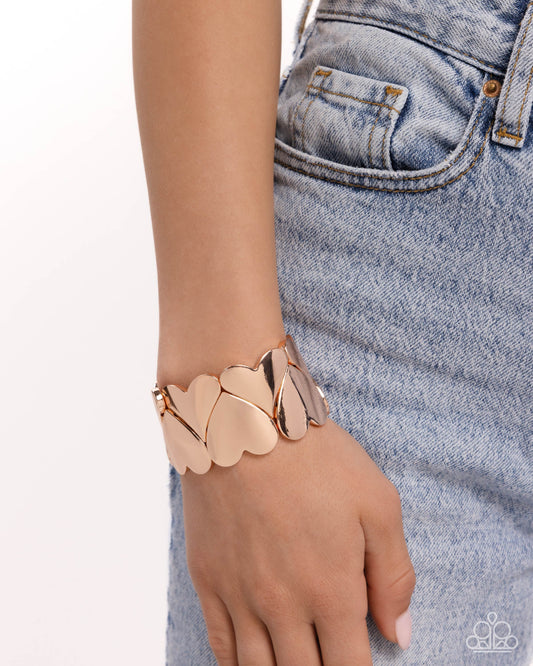 Sweetheart Setting Rose Gold Heart Stretch Bracelet - Paparazzi Accessories  Featuring a high-sheen, elongated rose gold heart frames are threaded along stretchy bands around the wrist, alternating in direction for a romantic look.  Sold as one individual bracelet.  P9ST-GDRS-079XX