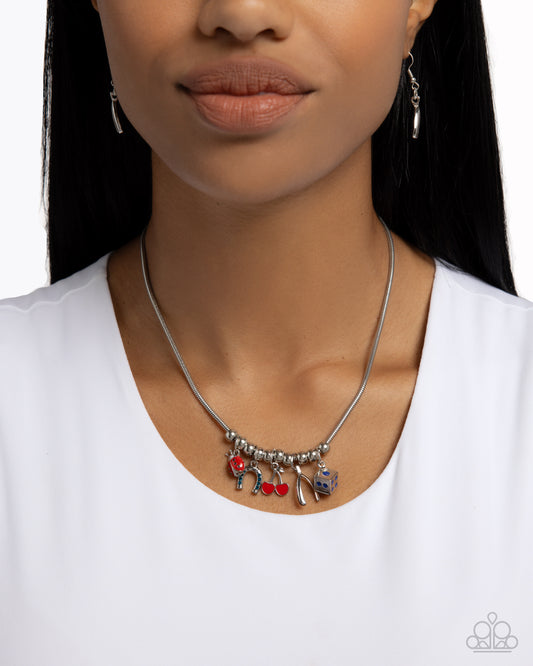 As Luck Would Have It Blue Necklace - Paparazzi Accessories  Gliding along a rounded silver snake chain, a collection of silver beads alternate with a collection of lucky charms including a red-and-blue-painted ladybug, a blue rhinestone-dotted upside-down horseshoe, a red-painted duo of cherries, a blue-painted die, and a silver wishbone. Features an adjustable clasp closure.  Sold as one individual necklace. Includes one pair of matching earrings.  P2DA-BLXX-197XX