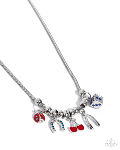 As Luck Would Have It Blue Necklace - Paparazzi Accessories  Gliding along a rounded silver snake chain, a collection of silver beads alternate with a collection of lucky charms including a red-and-blue-painted ladybug, a blue rhinestone-dotted upside-down horseshoe, a red-painted duo of cherries, a blue-painted die, and a silver wishbone. Features an adjustable clasp closure.  Sold as one individual necklace. Includes one pair of matching earrings.  P2DA-BLXX-197XX
