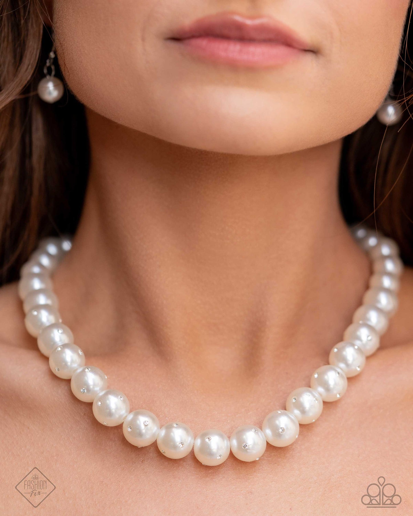 Dashing Definition White Pearl Necklace - Paparazzi Accessories  Infused along an invisible string, a collection of glossy white pearls, gradually dusted in dainty white rhinestones as it cascades towards the center of the neckline creates a radiantly, refined display. Features an adjustable clasp closure.  Sold as one individual necklace. Includes one pair of matching earrings.  P2RE-WTXX-694AY
