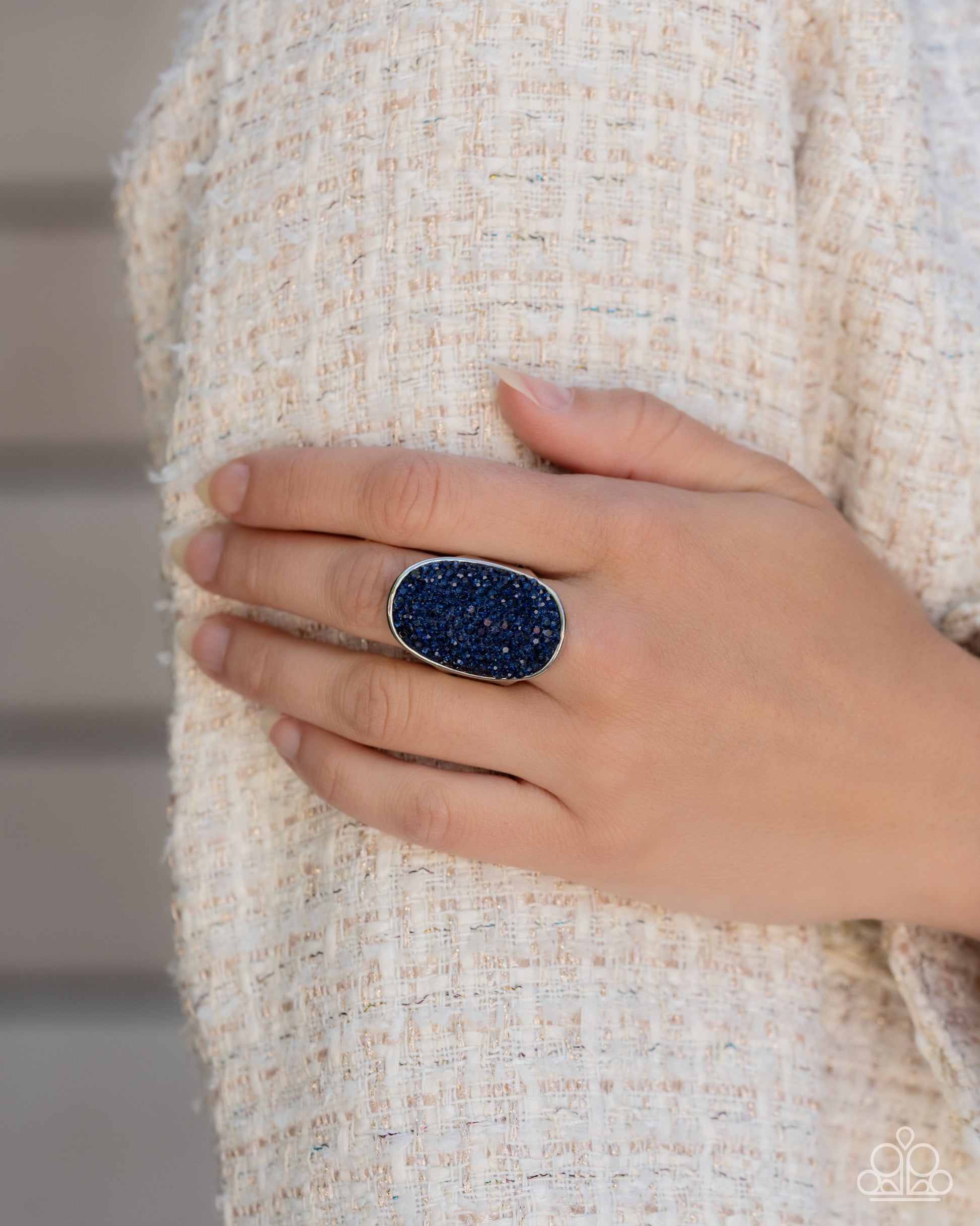 Exaggerated Elitist Blue Rhinestone Ring - Paparazzi Accessories  The front of a navy-painted oval silver frame is haphazardly encrusted in a blinding scatter of glassy Montana rhinestones, creating a dramatic centerpiece atop the finger. Features a stretchy band for a flexible fit.  Sold as one individual ring.  P4RE-BLXX-263XX