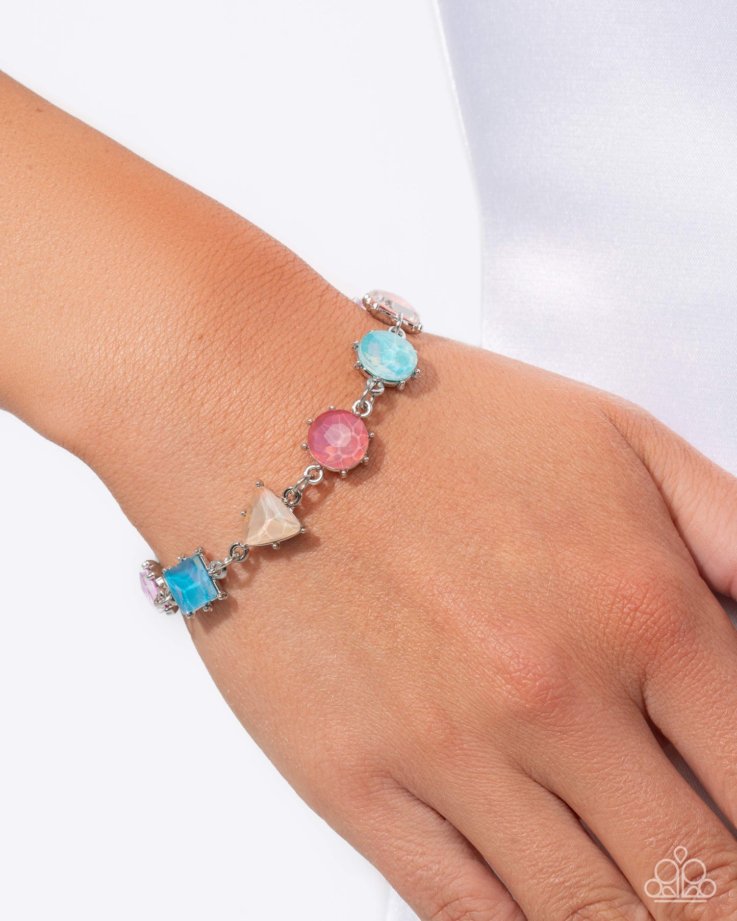 Bracelet with colorful beads on a wrist against a white background