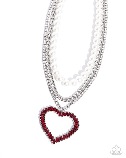 Y2K Year Red Heart Necklace - Paparazzi Accessories  Bold layers of a glistening silver curb chain, white rhinestones pressed in silver square fittings, and glossy white pearls, fall across the chest creating an edgy refined effect. Chiseled red gems in pronged silver fittings twist into an airy heart pendant that glides along the lowermost chain for a romantic finish. Features an adjustable clasp closure.  Sold as one individual necklace. Includes one pair of matching earrings.  P2ST-RDXX-142XX