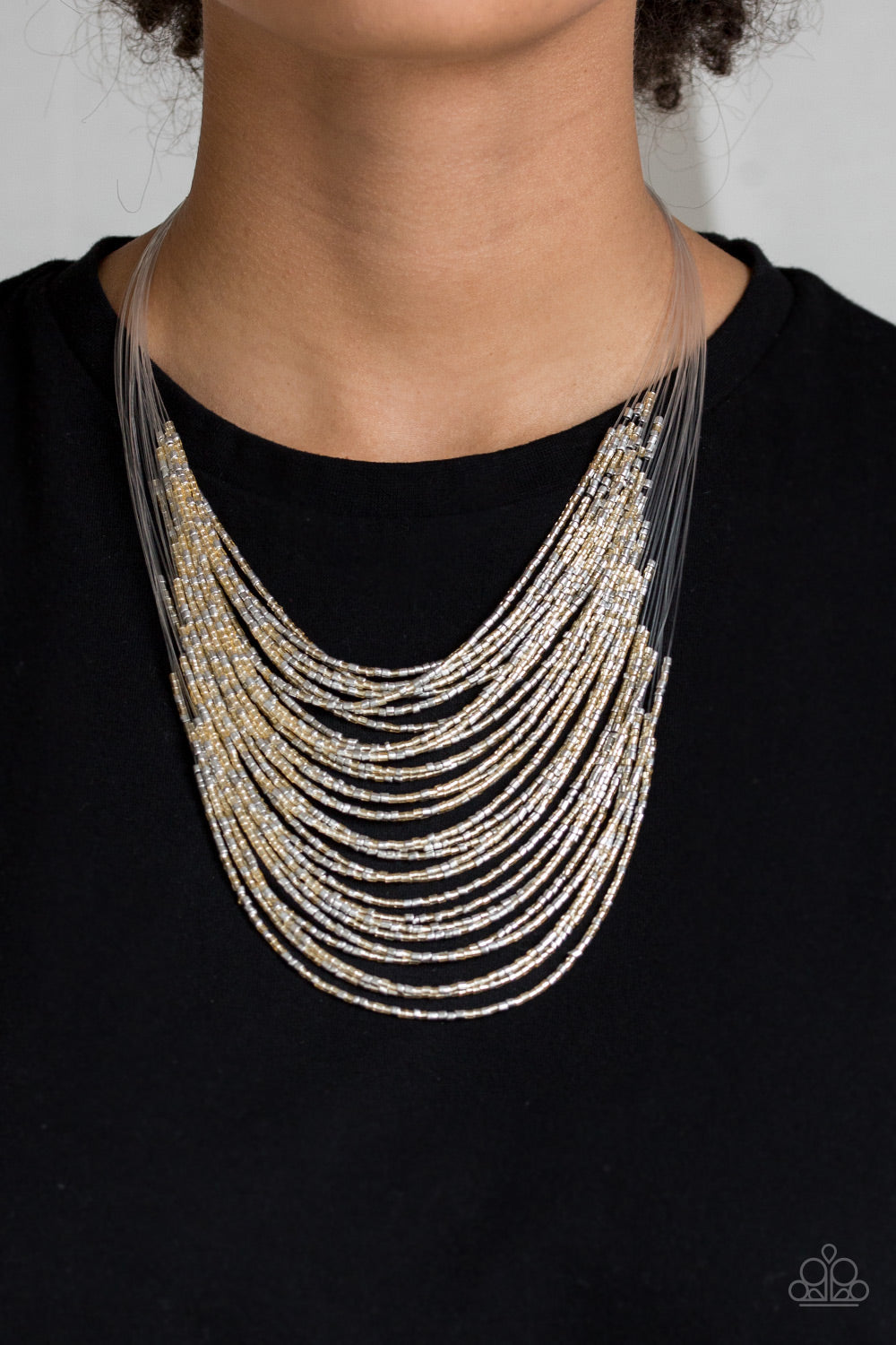 Catwalk Queen - Multi Item #N319 Strand after strand of metallic gold and silver seed beads fall together to create a bold statement piece. Features an adjustable clasp closure. All Paparazzi Accessories are lead free and nickel free!  Sold as one individual necklace. Includes one pair of matching earrings.