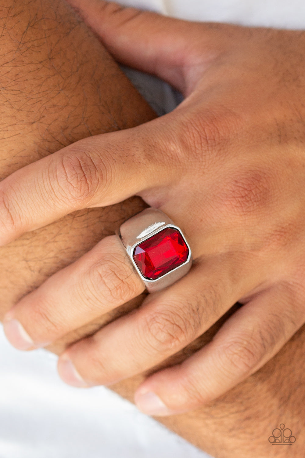 Scholar - Red Featuring a kingly emerald style cut, an oversized red rhinestone is pressed into the center of a glistening silver band for a statement look. Features a stretchy band for a flexible fit.  Sold as one individual ring.