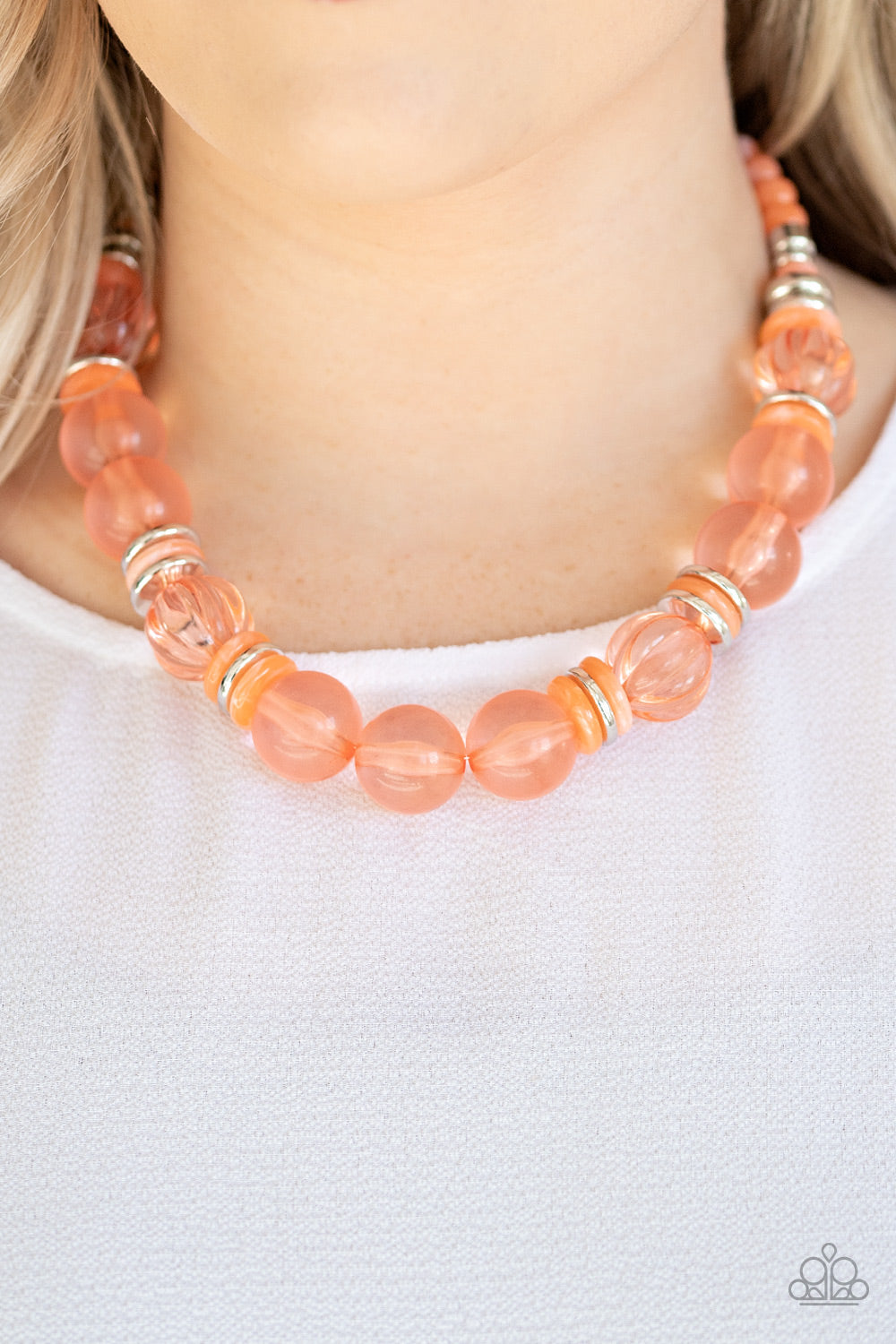 Bubbly Beauty - Orange Item #N762 Featuring dainty silver and orange acrylic discs, a collection of oversized glassy orange beads are threaded along an invisible wire below the collar for a colorfully bubbly look. Features an adjustable clasp closure. All Paparazzi Accessories are lead free and nickel free!  Sold as one individual necklace. Includes one pair of matching earrings.