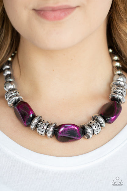 Colorfully Confident Purple Necklace - Paparazzi Accessories Item #N310 A collection of classic silver beads, ornate silver accents, and metallic purple faux rock beads are threaded along an invisible wire below the collar for a statement-making finish. Features an adjustable clasp closure. All Paparazzi Accessories are lead free and nickel free!  Sold as one individual necklace. Includes one pair of matching earrings.