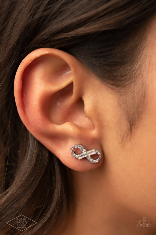 Turn Of The Century White Earring - Paparazzi Accessories  Glassy emerald-cut rhinestones embellish a radiant infinity. Dainty white rhinestones are sprinkled along the swooping silver frame, adding additional sparkling accents to the romantic design. Earring attaches to a standard post fitting.  Sold as one pair of post earrings. This Fan Favorite is back in the spotlight at the request of our 2021 Life of the Party member with Black Diamond Access, Courtney K.