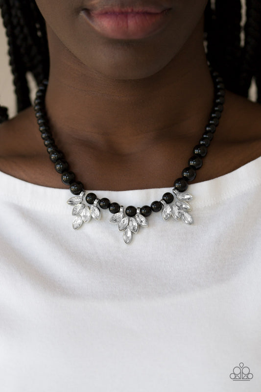 Society Socialite Black Necklace - Paparazzi Accessories Item #JJG-N7 A strand of shiny black beads drapes elegantly below the collar. Featuring regal marquise style cuts, glittery white rhinestone frames swing from the beaded strand for a timeless finish. Features an adjustable clasp closure.  Sold as one individual necklace. Includes one pair of matching earrings.