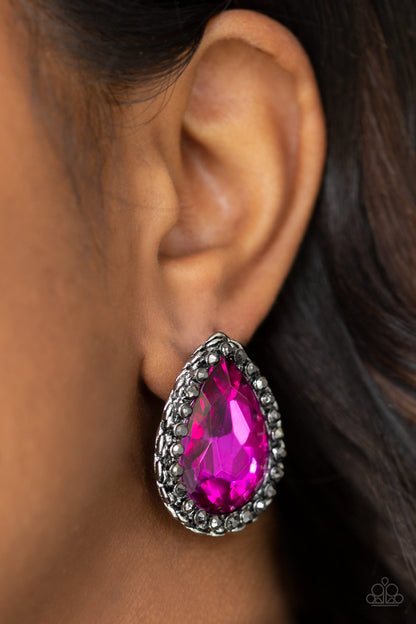 Dare To Shine - Pink Item #E427 Encrusted in a ring of glittery hematite rhinestones, an overly dramatic pink teardrop gem is pressed into a textured silver frame for a grunge-glamorous look. Earring attaches to a standard post fitting. All Paparazzi Accessories are lead free and nickel free!  Sold as one pair of post earrings.