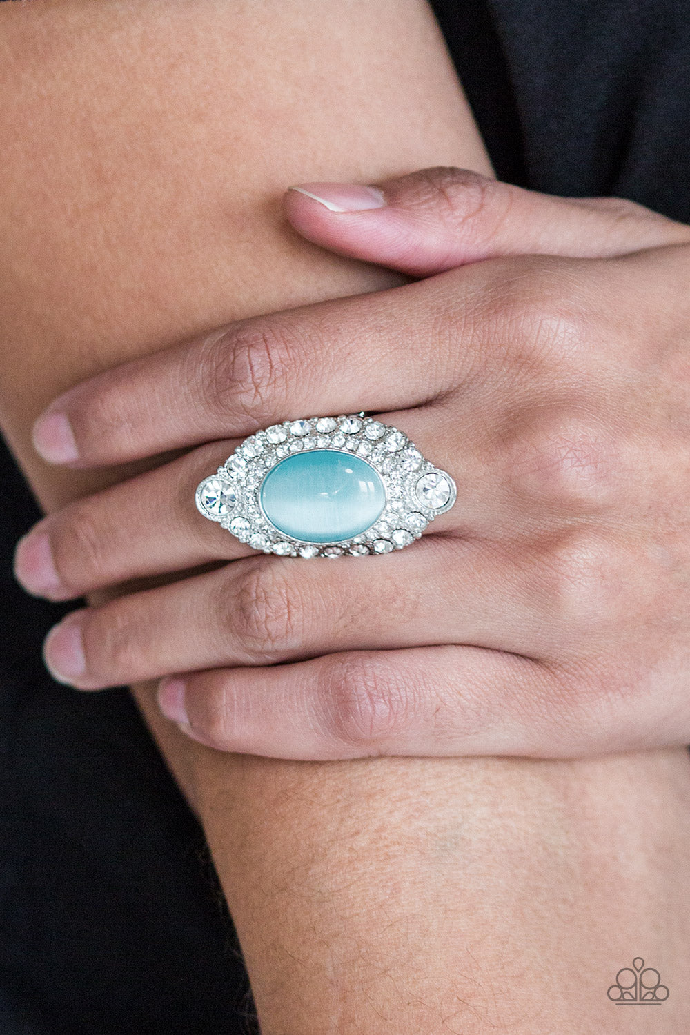 Riviera Royalty - Blue A glowing blue moonstone is pressed into a dramatic silver band radiating with glassy white rhinestones for a glamorous flair. Features a stretchy band for a flexible fit.  Sold as one individual ring.