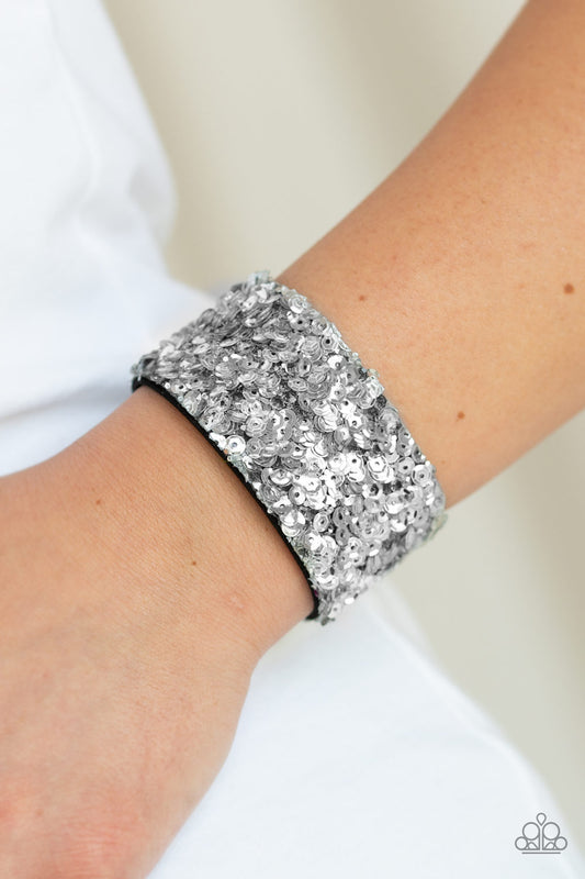 Starry Sequins - Silver  A collision of glittery rhinestones and sparkling silver sequins are encrusted along the front of a black suede band, creating blinding shimmer around the wrist. Features an adjustable snap closure.&nbsp;  Sold as one individual bracelet.  SKU: P9UR-SVXX-165XX
