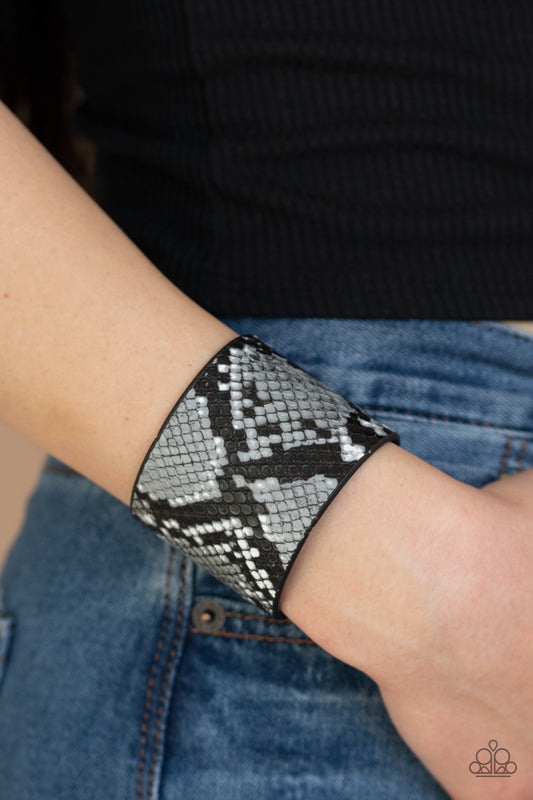 The Rest Is HISS-tory Silver Animal Print Wrap Bracelet - Paparazzi Accessories  Featuring gray and black python print, a thick black leather band wraps around the wrist for a wild fashion. Features an adjustable snap closure.  Sold as one individual bracelet.&nbsp;