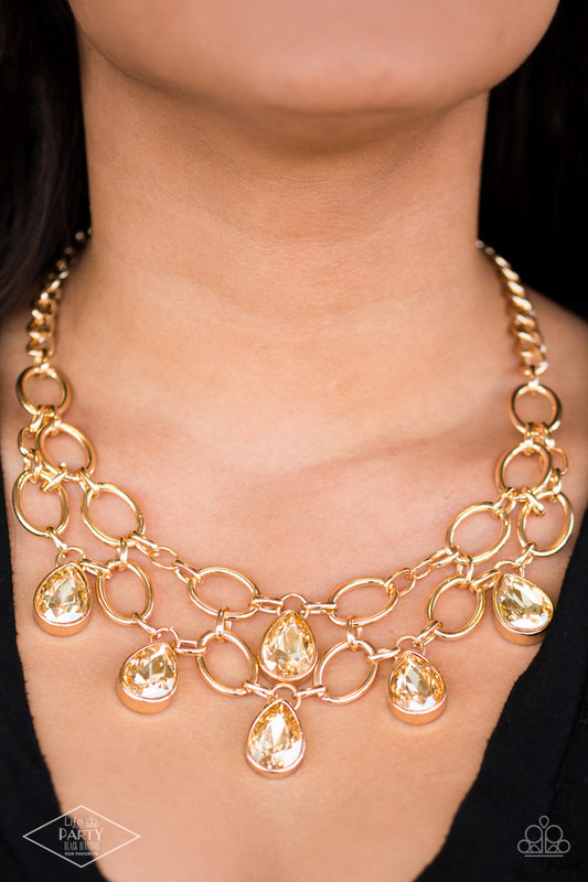 Show-Stopping Shimmer Gold Necklace - Paparazzi Accessories  Joined by dainty gold links, two rows of dramatic gold chain layer below the collar in a fierce fashion. Golden teardrops drip from the glistening layers, adding a timeless shimmer to the show-stopping piece. Features an adjustable clasp closure.  Includes one pair of matching earrings. This Fan Favorite is back in the spotlight at the request of our 2021 Life of the Party member with Black Diamond Access, Shayla S.