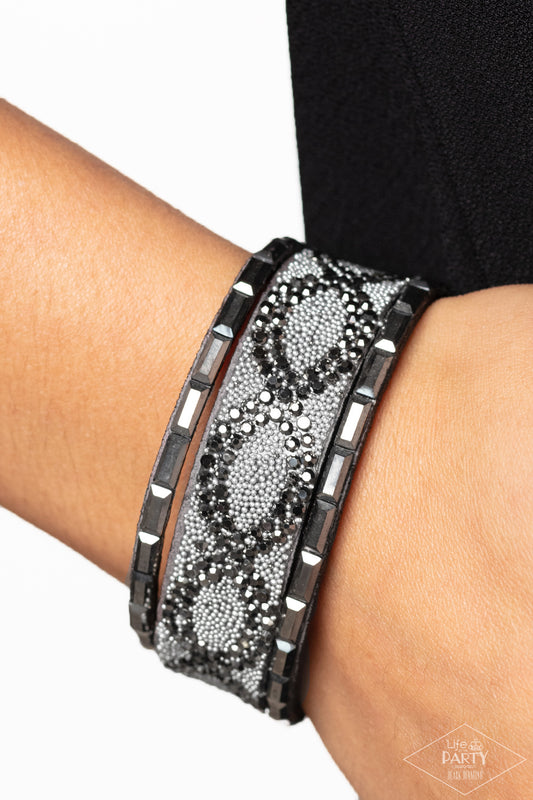 Put On Your BEAST Face Silver Wrap Bracelet - Paparazzi Accessories  Flanked by rows of emerald-cut hematite rhinestones, dainty metallic beads and glittery hematite rhinestone are sprinkled across the center of a gray suede band, creating a daring diamond pattern across the wrist. Features an adjustable snap closure.  Sold as one individual bracelet.  New KitENCORE This Black Diamond Encore is back in the spotlight at the request of our 2022 Life of the Party member with Black Diamond Access, Jami W.