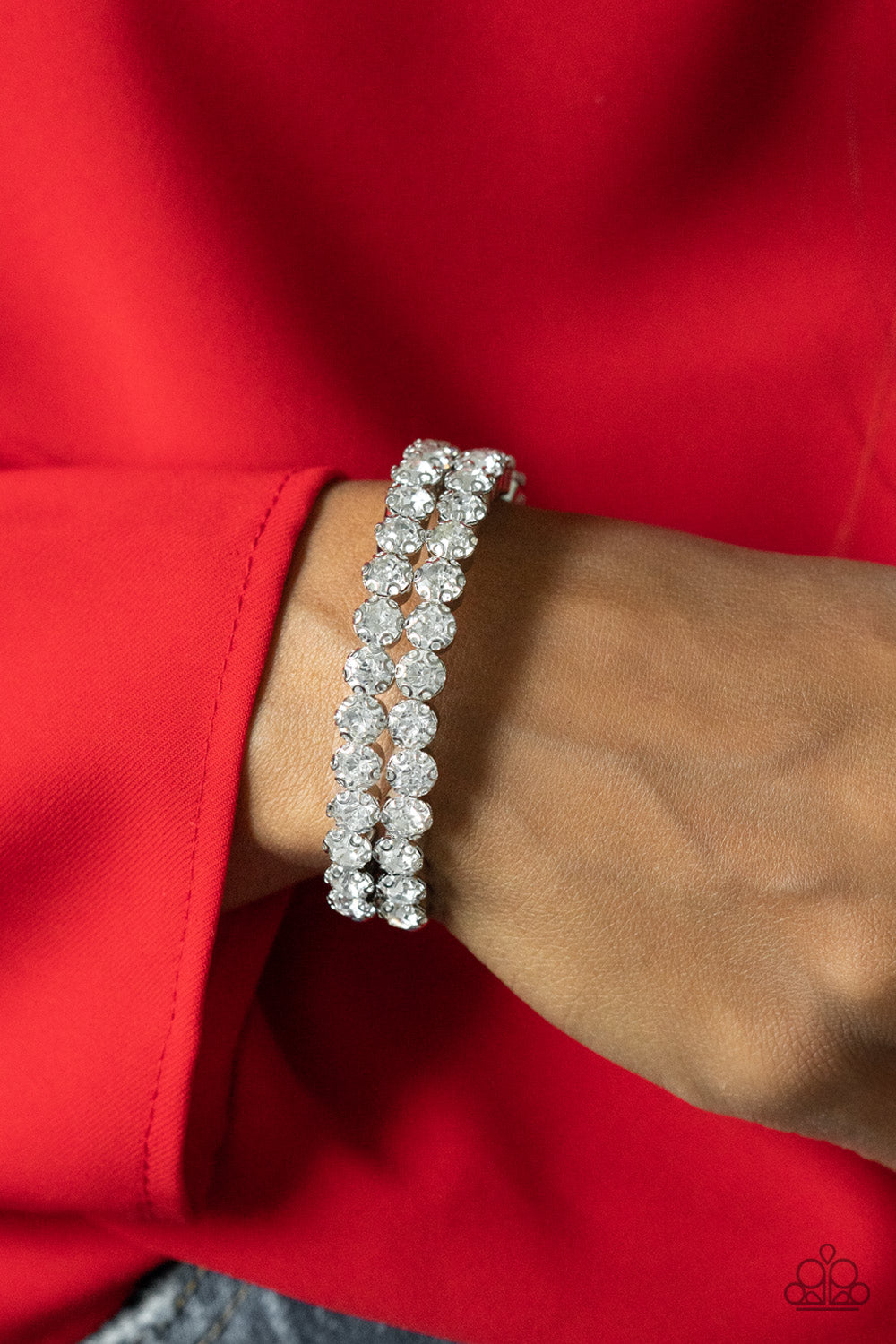 Megawatt Majesty White Cuff Bracelet - Paparazzi Accessories  Encased in sleek silver fittings, two oversized rows of glassy white rhinestones stack into a blinding cuff around the wrist for a jaw-dropping look.  Sold as one individual bracelet.