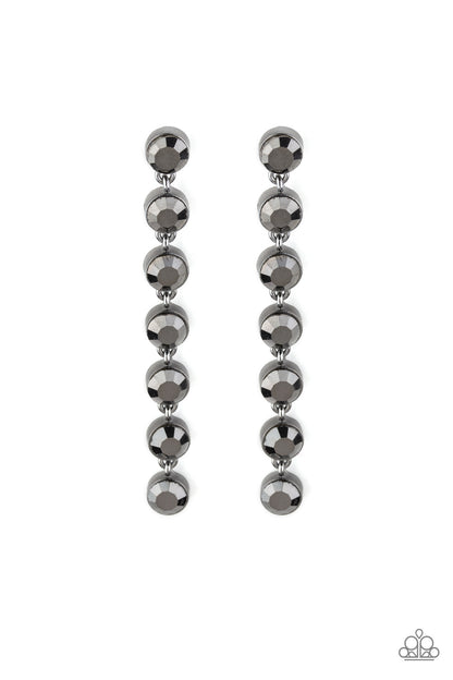 Dazzling Debonair - Black Item #E402 Featuring sleek gunmetal fittings, a collection of oversized hematite rhinestones drip from the ear for a glamorous look. Earring attaches to a standard post fitting. All Paparazzi Accessories are lead free and nickel free!  Sold as one pair of post earrings.