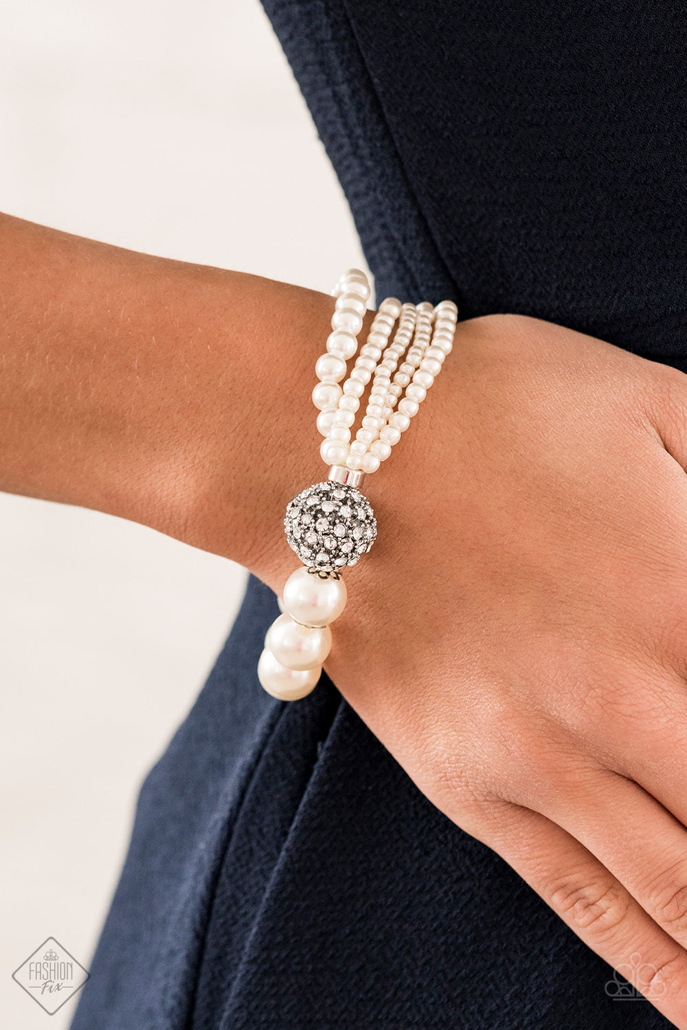 Show Them The DOOR White Bracelet - Paparazzi Accessories Item #B335 Featuring comfortable stretchy bands, a white rhinestone-encrusted silver bead connects strands of mismatched white pearls and a single strand of classic white pearls around the wrist in a timeless twist. All Paparazzi Accessories are lead free and nickel free!  Sold as one individual bracelet.