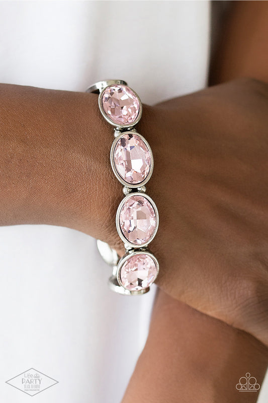 DIVA In Disguise Pink Bracelet - Paparazzi Accessories  Glassy pink gems are pressed into sleek silver frames. Infused with dainty silver beads, the glittery frames are threaded along stretchy elastic bands for a glamorous look around the wrist.  Sold as one individual bracelet. This Fan Favorite is back in the spotlight at the request of our 2021 Life of the Party member with Black Diamond Access, Valerie H.