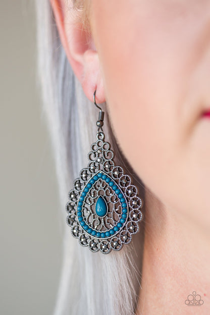 Carnival Courtesan Blue Earring - Paparazzi Accessories  Regal gunmetal filigree climbs a teardrop shaped frame, coalescing into a glistening frame. Dainty blue beads adorn the center of the frame, while glittery hematite rhinestones embellish the outer frame for a refined finish. Earring attaches to a standard fishhook fitting.  All Paparazzi Accessories are lead free and nickel free!  Sold as one pair of earrings.
