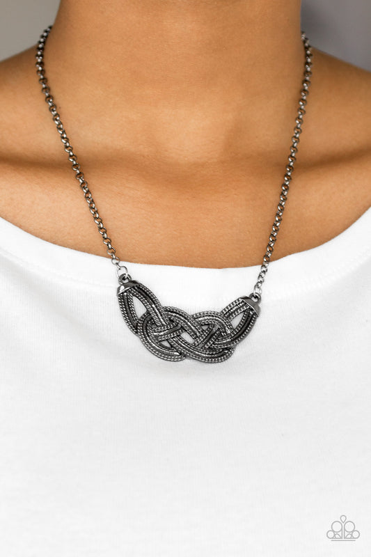 Nautically Naples Black Necklace - Paparazzi Accessories  Featuring chain-like patterns, antiqued gunmetal bars knot below the collar for a bold industrial look. Features an adjustable clasp closure.  All Paparazzi Accessories are lead free and nickel free!  Sold as one individual necklace. Includes one pair of matching earrings.