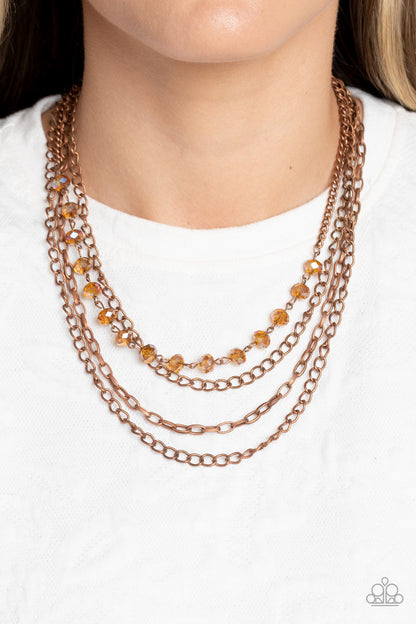 Extravagant Elegance Copper Necklace - Paparazzi Accessories  Mismatched copper chains layer down the chest. Dipped in a coppery metallic sheen, a strand of faceted black beads join below the collar for a glamorous look. Features an adjustable clasp closure.  Sold as one individual necklace. Includes one pair of matching earrings.