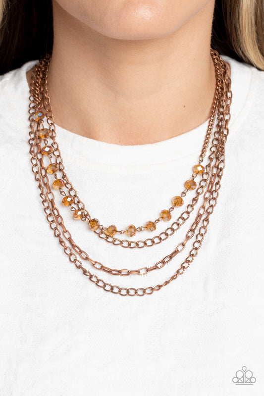 Extravagant Elegance Copper Necklace - Paparazzi Accessories  Mismatched copper chains layer down the chest. Dipped in a coppery metallic sheen, a strand of faceted black beads join below the collar for a glamorous look. Features an adjustable clasp closure.  Sold as one individual necklace. Includes one pair of matching earrings.