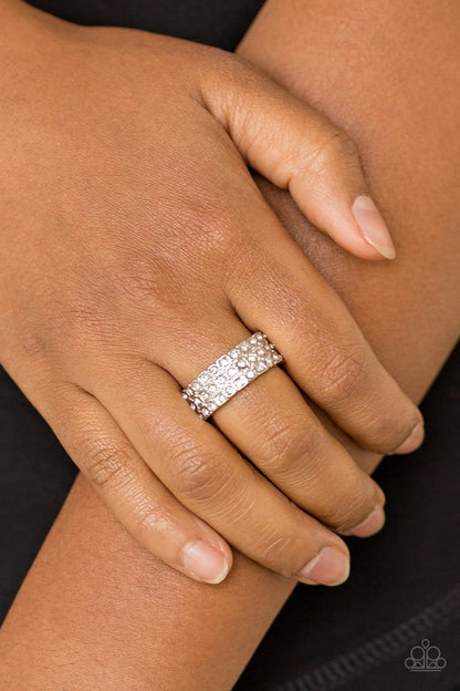 Feeling Fab-YOU-less White Ring - Paparazzi Accessories  Row after row of dazzling white rhinestones are encrusted along a dainty silver band, creating timeless shimmer. Features a dainty stretchy band for a flexible fit.  All Paparazzi Accessories are lead free and nickel free!   Sold as one individual ring.