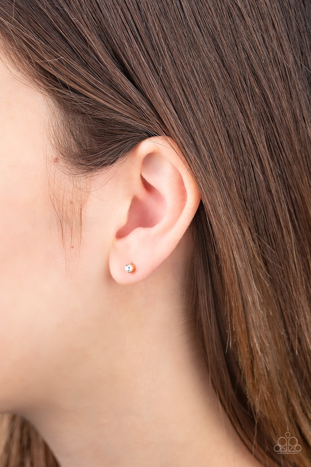 Dainty Decor - Gold Item #E267 A dainty white cubic zirconia is pressed into the center of a sleek gold frame for a timeless look. Earring attaches to a standard post fitting. Features a daintier design to accommodate multiple ear piercings. All Paparazzi Accessories are lead free and nickel free!  Sold as one pair of post earrings.